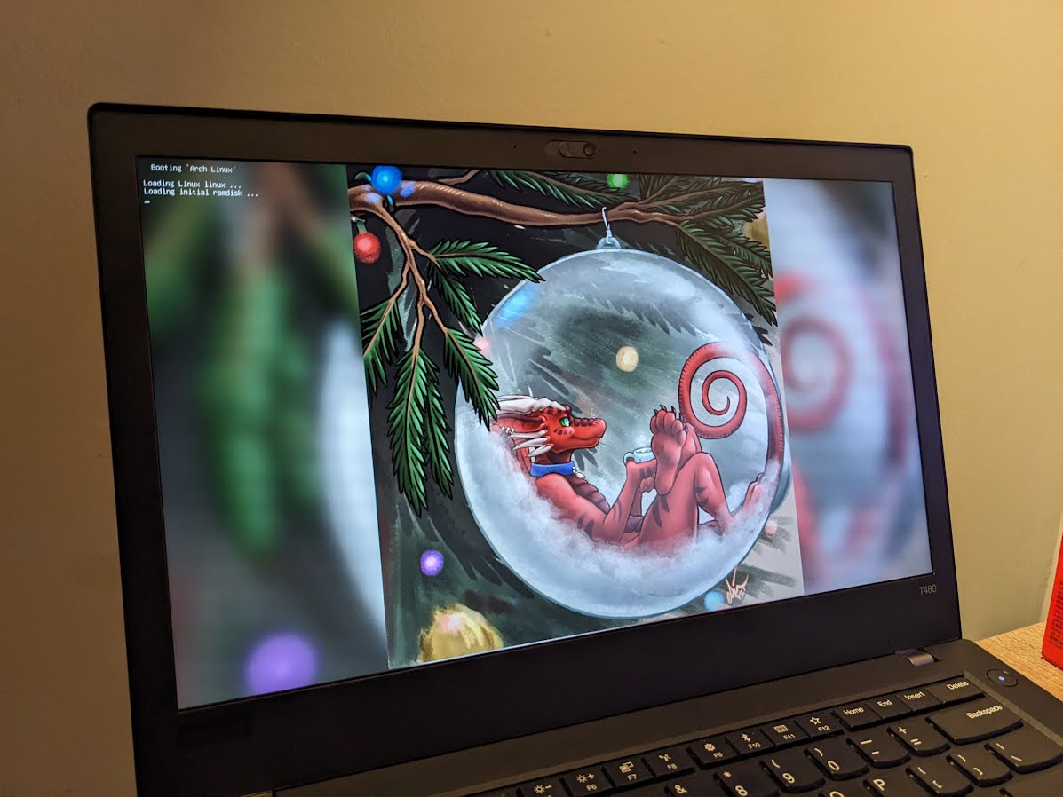 Photo of the new laptop, with some holiday art on the boot menu